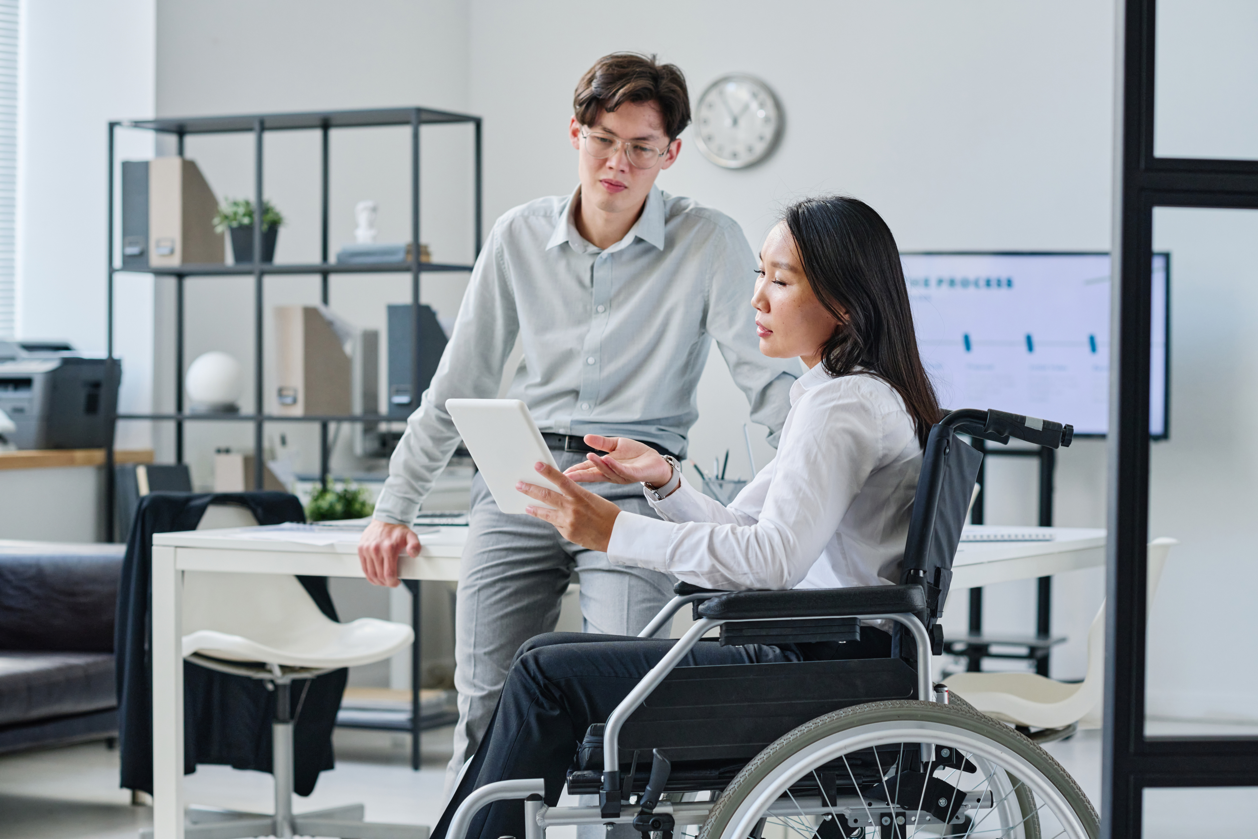 Dues persones treballant juntes revisant l'accessibilitat en una tablet